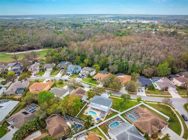 aerial view featuring a wooded view and a residential view