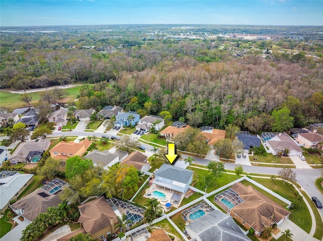 birds eye view of property with a residential view and a wooded view