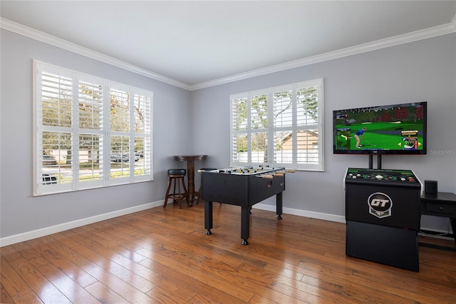 recreation room featuring crown molding, baseboards, and wood-type flooring