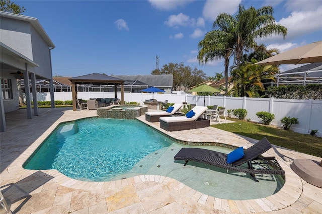 view of swimming pool with a gazebo, a pool with connected hot tub, a patio area, and a fenced backyard