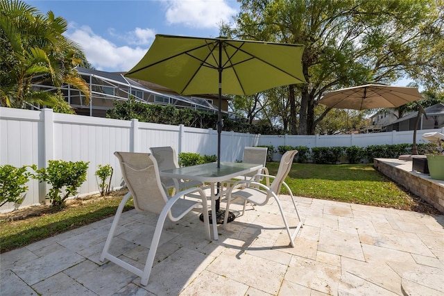 view of patio with outdoor dining space and a fenced backyard