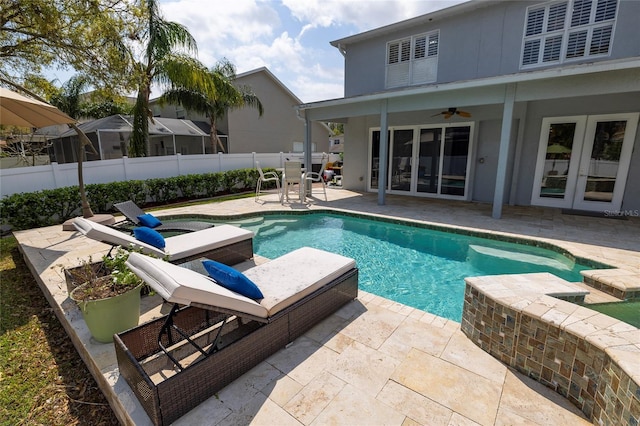 view of pool featuring a fenced in pool, ceiling fan, fence, french doors, and a patio