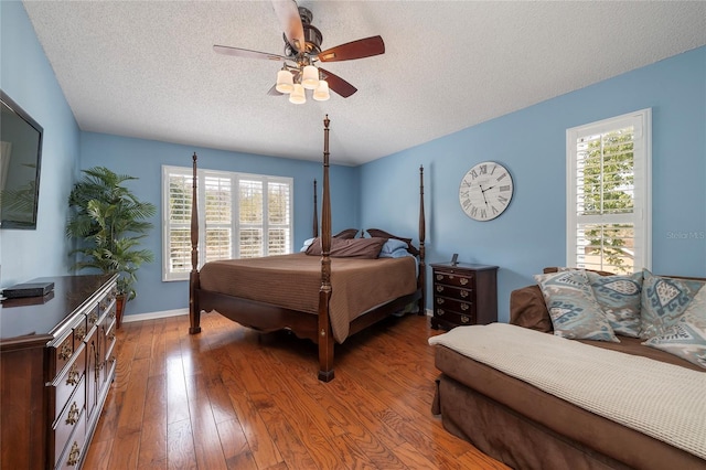 4859 Augusta Ave, Oldsmar, FL 34677 - bedroom featuring a textured ceiling, hardwood / wood-style flooring, and a ceiling fan