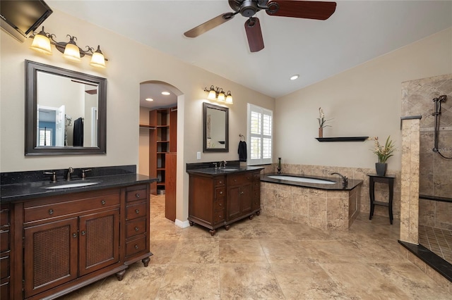 4859 Augusta Ave, Oldsmar, FL 34677 - full bathroom featuring ceiling fan, tiled shower, a bath, two vanities, and lofted ceiling