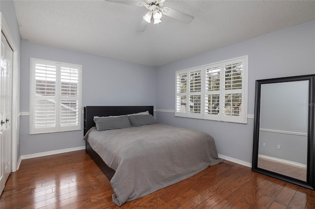 4859 Augusta Ave, Oldsmar, FL 34677 - bedroom with hardwood / wood-style floors, multiple windows, a textured ceiling, ceiling fan, and a closet