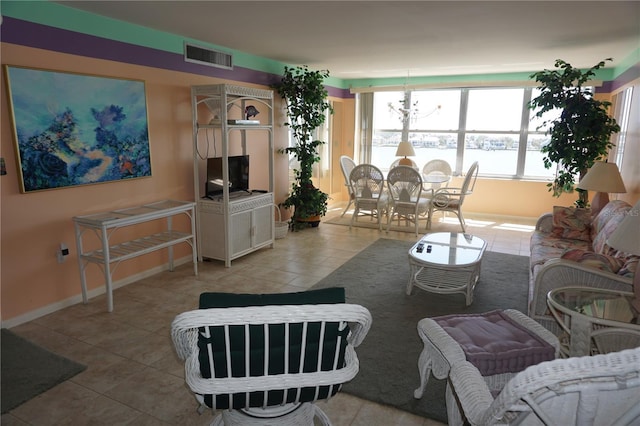 tiled living room with visible vents and baseboards