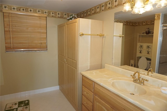 bathroom with vanity, toilet, baseboards, and tile patterned flooring