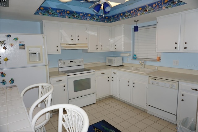 kitchen featuring white cabinetry, white appliances, under cabinet range hood, and a sink