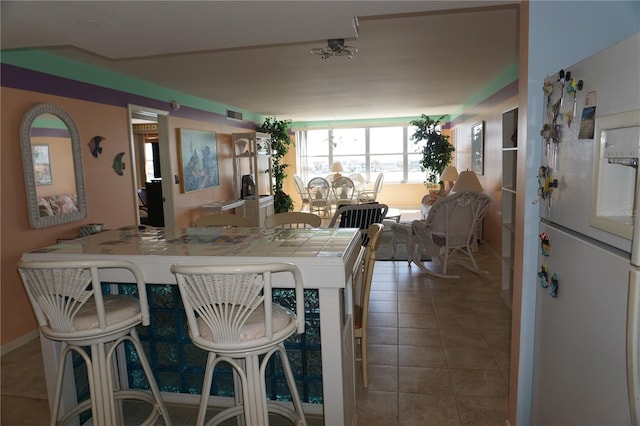 dining space featuring tile patterned flooring, baseboards, and visible vents