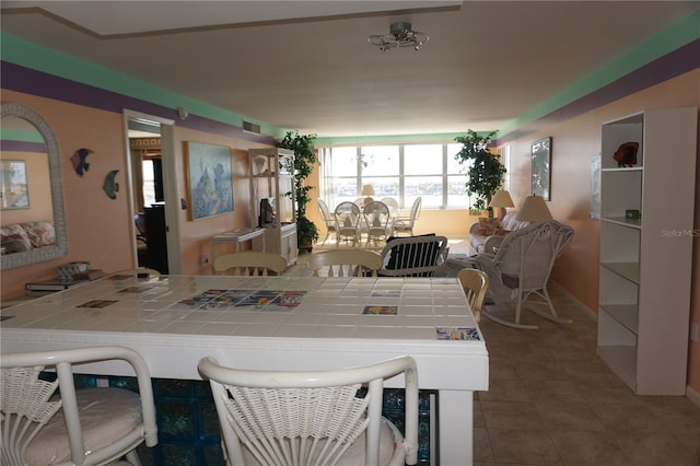 dining space with tile patterned flooring and visible vents