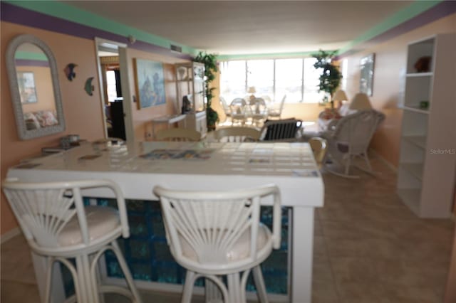 dining room featuring tile patterned flooring and baseboards