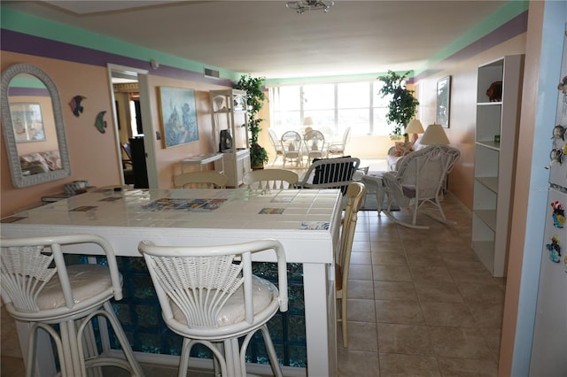 tiled dining room with visible vents