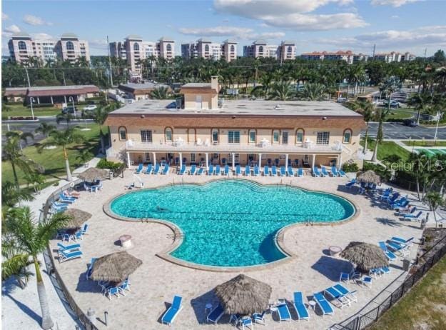 pool with a view of city and a patio area