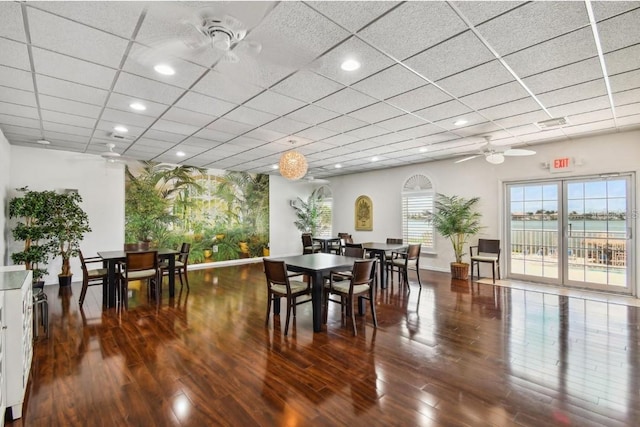 dining room with a ceiling fan, recessed lighting, wood finished floors, and a drop ceiling