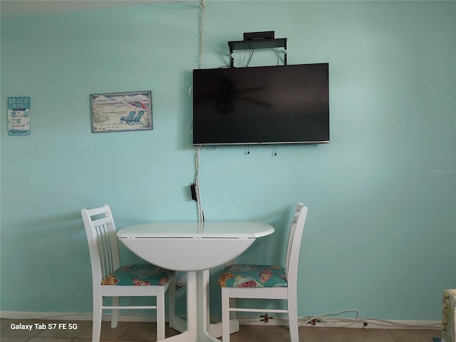 dining room featuring baseboards and tile patterned flooring