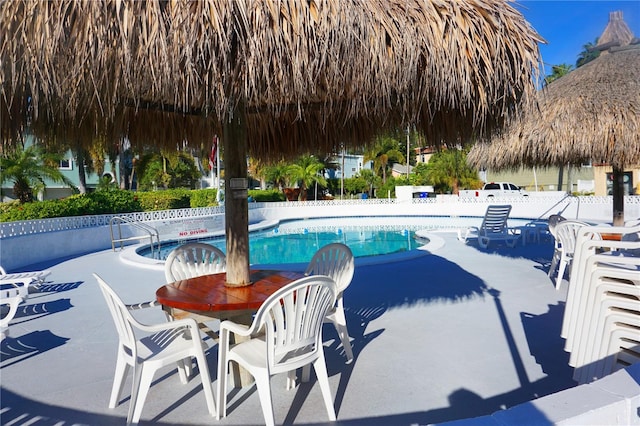 community pool featuring a patio area and fence