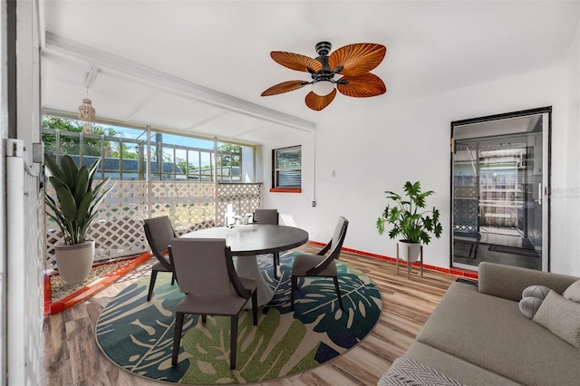 dining area featuring ceiling fan, baseboards, and wood finished floors