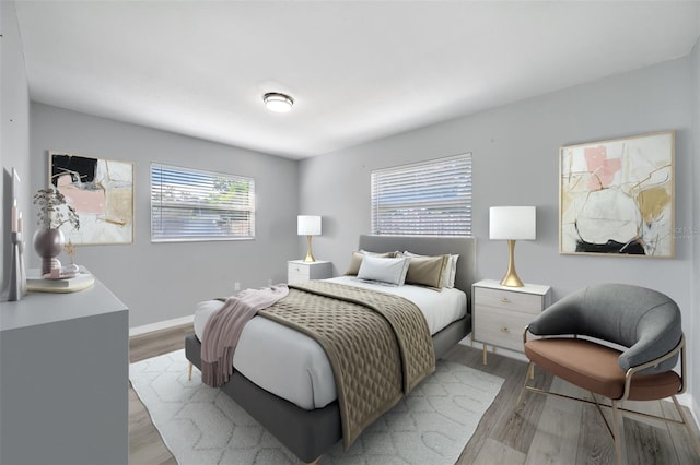 bedroom featuring light wood-type flooring and baseboards