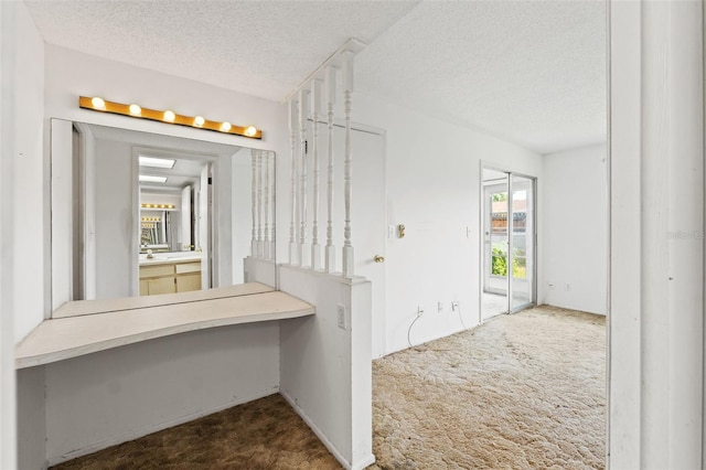 bathroom with a textured ceiling and vanity