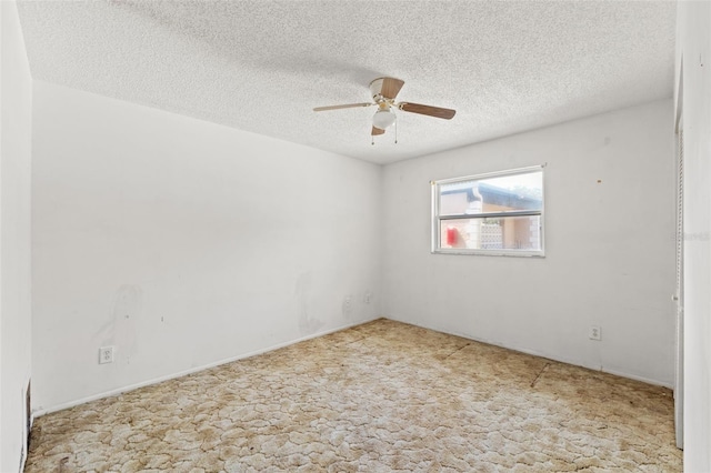 empty room with a textured ceiling, ceiling fan, and carpet floors