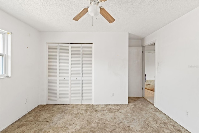 unfurnished bedroom featuring a closet, a textured ceiling, and carpet flooring