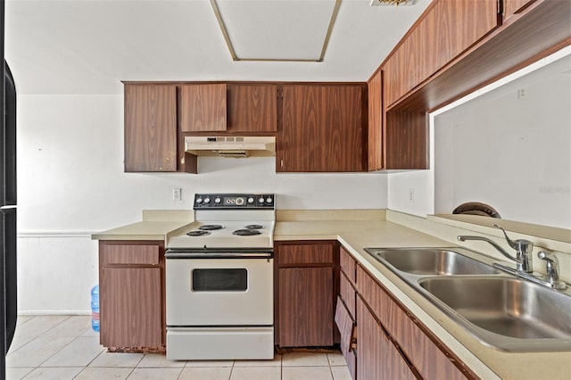 kitchen featuring light countertops, electric stove, under cabinet range hood, and a sink