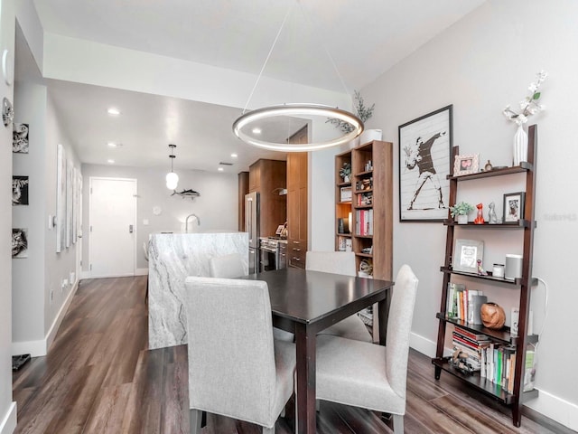 dining space with recessed lighting, baseboards, and dark wood-style flooring