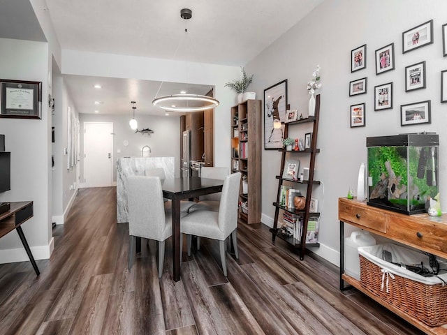 dining area featuring recessed lighting, dark wood-type flooring, and baseboards