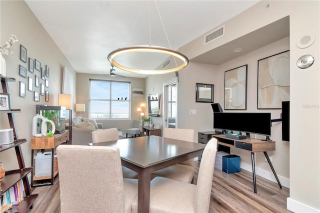 dining room with visible vents, baseboards, and wood finished floors