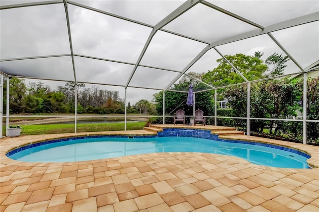 pool with a lanai and a patio area