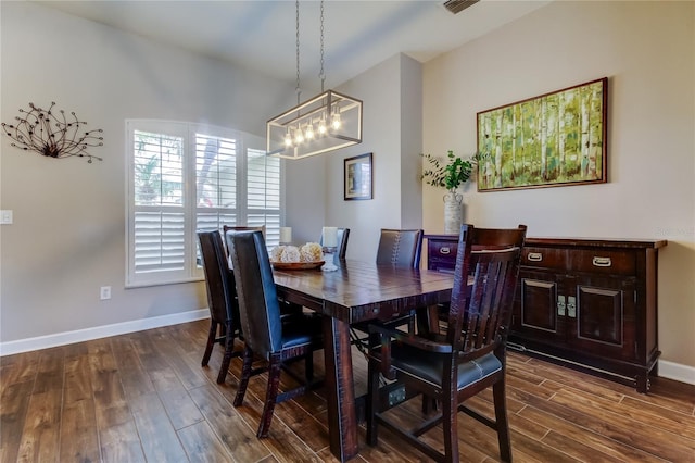 dining room with a chandelier, visible vents, dark wood-type flooring, and baseboards