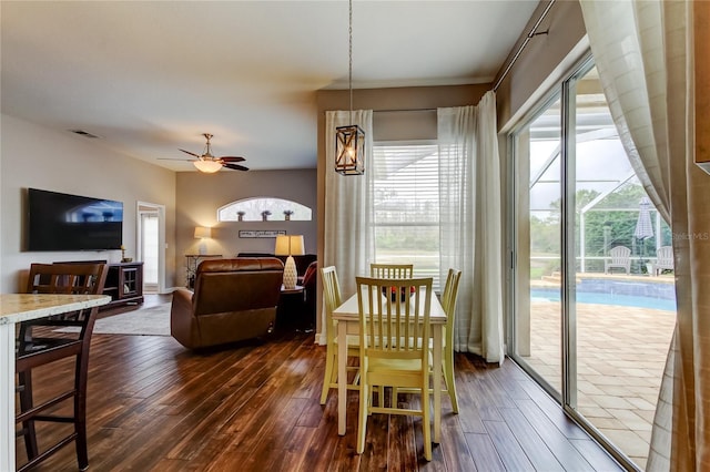 dining space with dark wood finished floors, visible vents, and ceiling fan