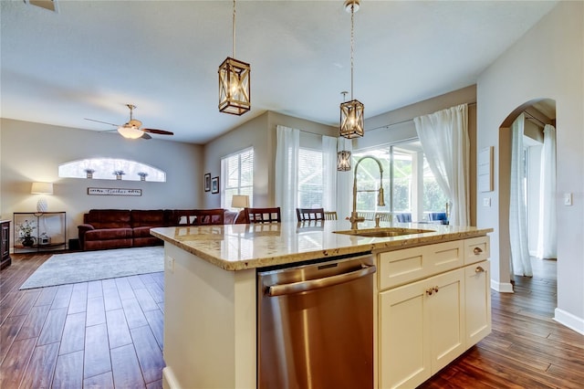 kitchen featuring a sink, arched walkways, stainless steel dishwasher, and dark wood finished floors