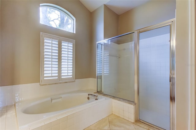 full bathroom with tile patterned flooring, a bath, and a stall shower