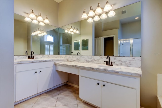 bathroom with a sink, double vanity, a shower stall, and tile patterned floors