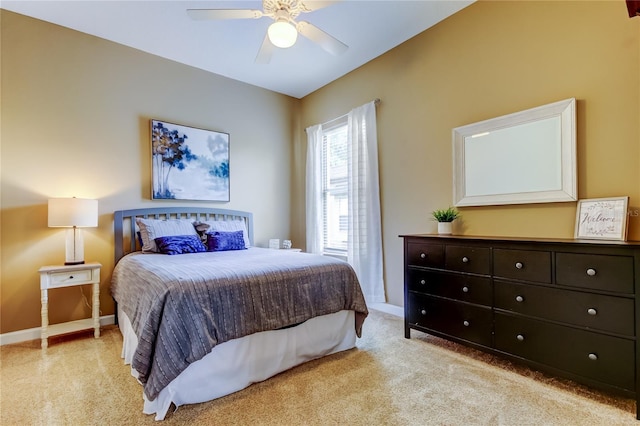 bedroom with light colored carpet, a ceiling fan, and baseboards