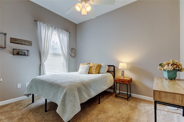 bedroom featuring a ceiling fan, light colored carpet, and baseboards