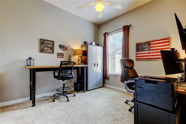 carpeted office featuring baseboards and a ceiling fan