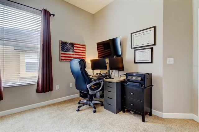 carpeted office featuring baseboards