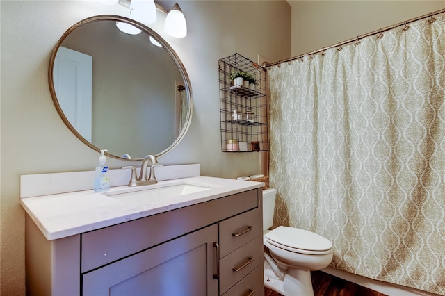 bathroom with curtained shower, toilet, vanity, and wood finished floors