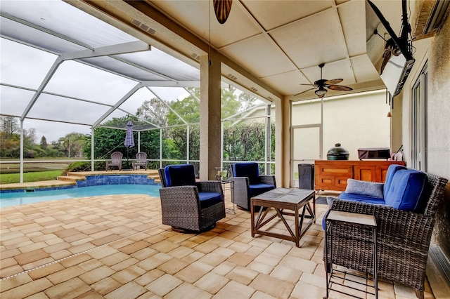 view of patio / terrace featuring a lanai, a ceiling fan, an outdoor pool, and an outdoor hangout area