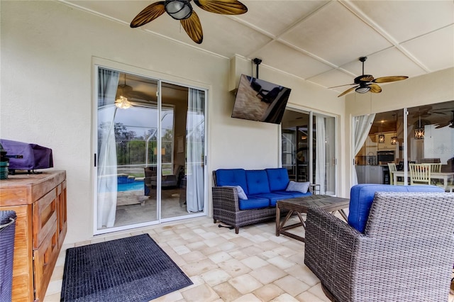 view of patio with an outdoor living space and a ceiling fan