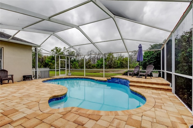 outdoor pool featuring a patio area and a lanai