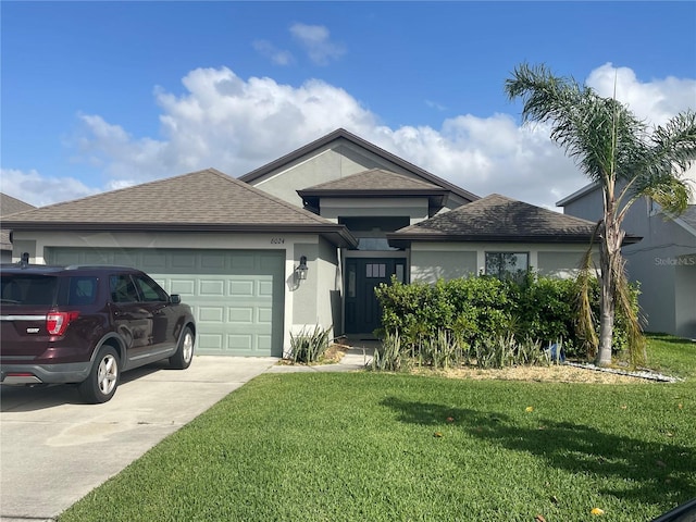 ranch-style house with stucco siding, a front lawn, driveway, roof with shingles, and a garage