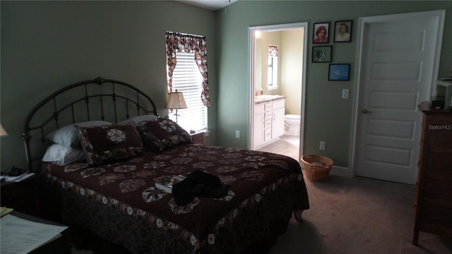 carpeted bedroom with connected bathroom