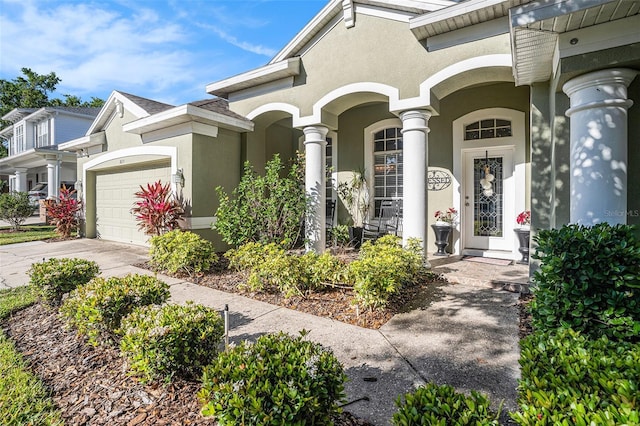 view of front of property featuring a garage, driveway, and stucco siding