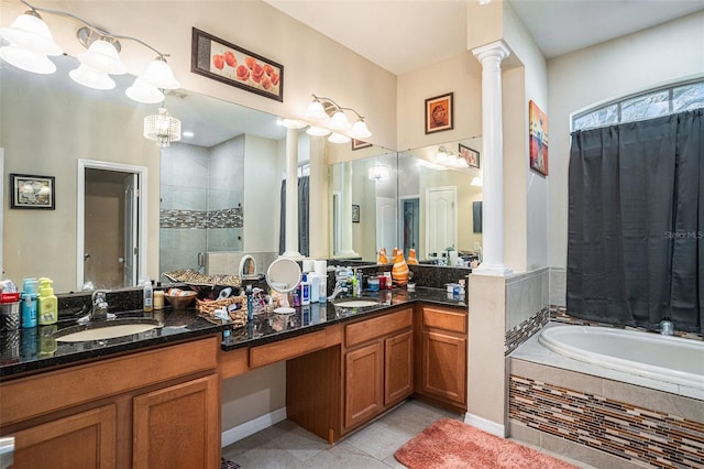 full bathroom with tile patterned floors, a shower stall, a garden tub, and decorative columns