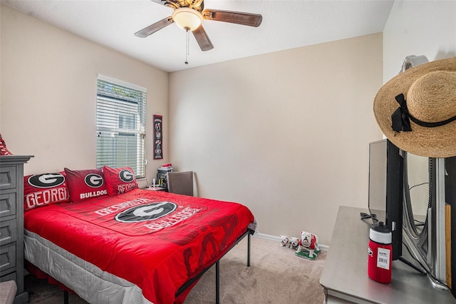 carpeted bedroom with a ceiling fan and baseboards