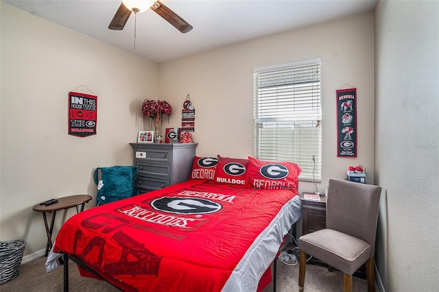 carpeted bedroom with ceiling fan and baseboards