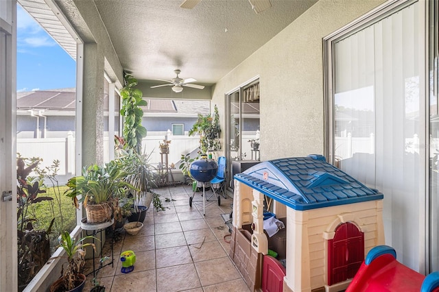 view of patio / terrace with ceiling fan and fence